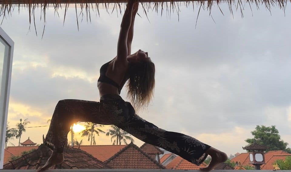 Yoga silhouette on sunset cafe terrace in Berawa, Canggu, Bali